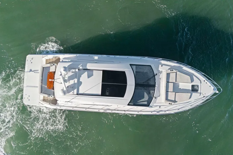 Simply Complicated Yacht Photos Pics Aerial view of 2019 Cruisers Yachts 54 Cantius navigating through water.