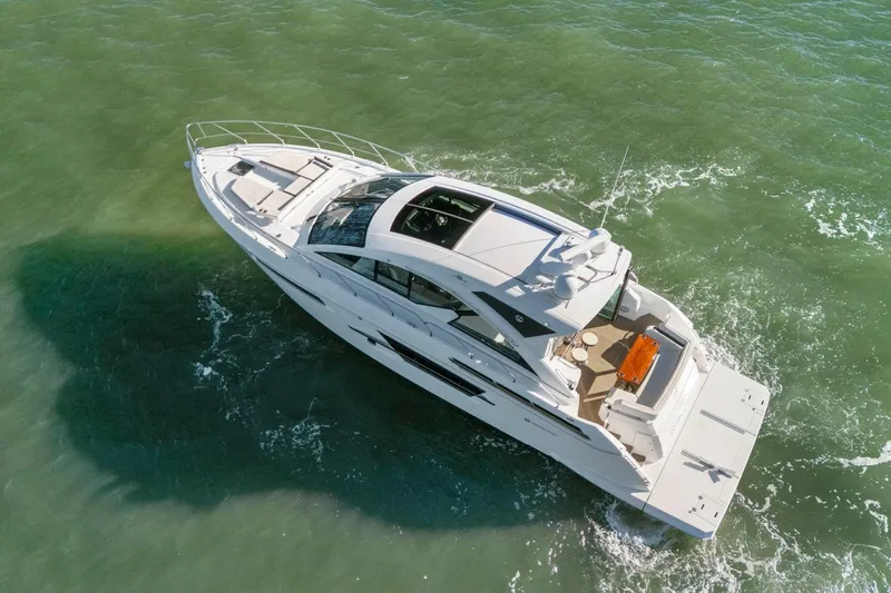 Simply Complicated Yacht Photos Pics 2019 Cruisers Yachts 54 Cantius cruising on open water, aerial view.