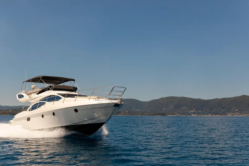 Shine IV Yacht Photos Pics Luxury Azimut 43 yacht cruising on open water, 2006 model.