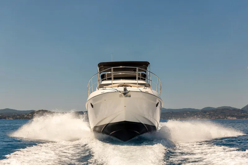 Shine IV Yacht Photos Pics 2006 Azimut 43 yacht cruising on open water, creating a wake.