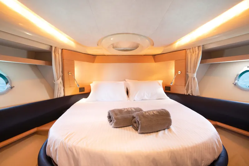 Shine IV Yacht Photos Pics Luxurious bedroom interior of 2006 Azimut 43 yacht with elegant lighting and cozy bedding.