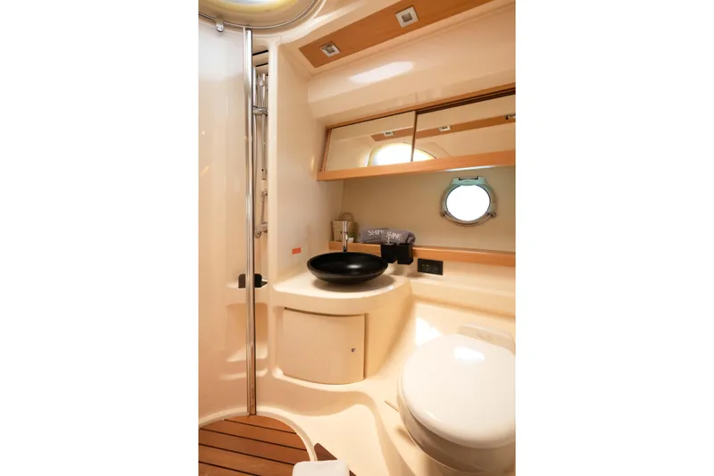 Shine IV Yacht Photos Pics Luxurious bathroom interior of 2006 Azimut 43 yacht with modern fixtures and porthole window.
