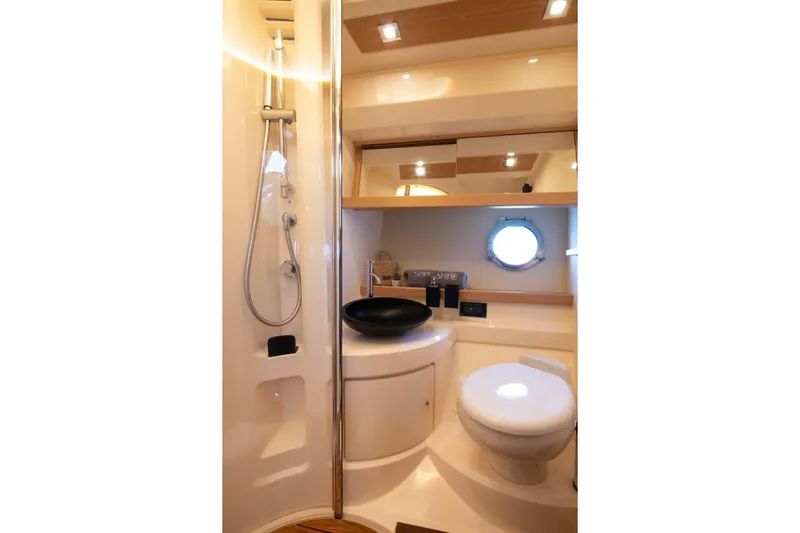Shine IV Yacht Photos Pics Luxurious 2006 Azimut 43 yacht bathroom with modern fixtures and elegant design.