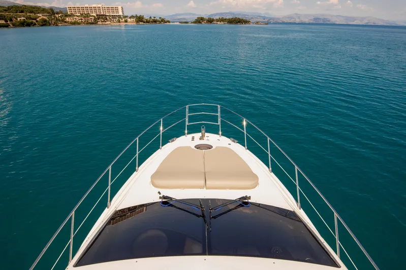 Shine IV Yacht Photos Pics Bow view of 2006 Azimut 43 yacht cruising on calm blue waters.