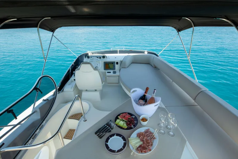 Shine IV Yacht Photos Pics Luxurious 2006 Azimut 43 yacht interior with elegant dining setup on turquoise waters.