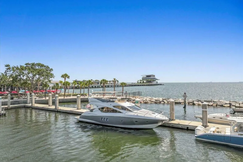 Cheers Yacht Photos Pics 2009 Sunseeker Manhattan 52 yacht docked in a scenic marina setting.