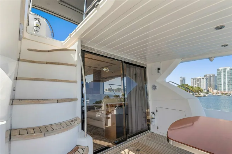 Cheers Yacht Photos Pics Luxurious 2009 Sunseeker Manhattan 52 yacht interior with staircase and waterfront view.