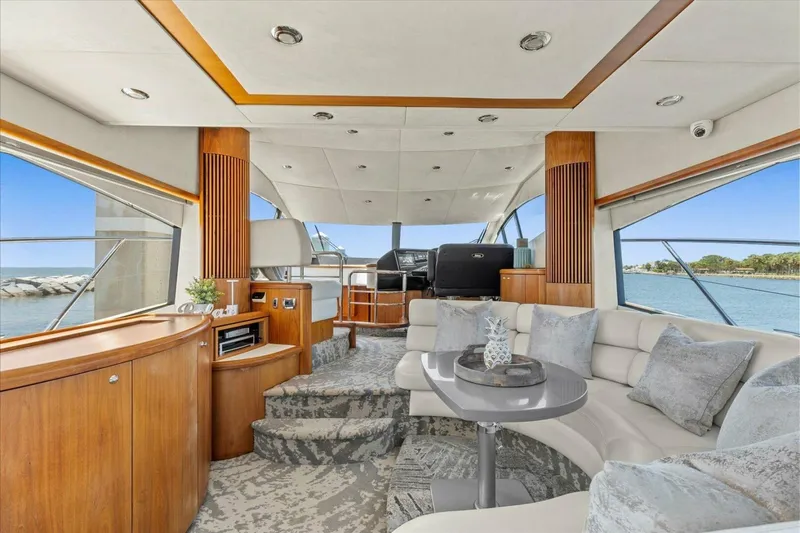 Cheers Yacht Photos Pics Luxurious interior of 2009 Sunseeker Manhattan 52 yacht with elegant seating and panoramic windows.