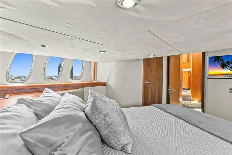 Cheers Yacht Photos Pics Luxurious bedroom interior of 2009 Sunseeker Manhattan 52 yacht with ocean view windows.