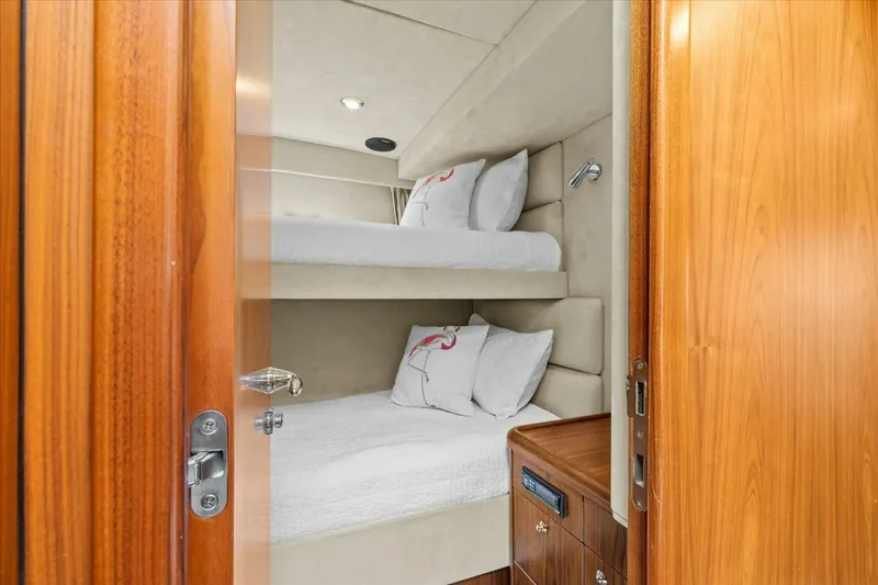 Cheers Yacht Photos Pics Bunk beds in 2009 Sunseeker Manhattan 52 yacht cabin with wooden door.