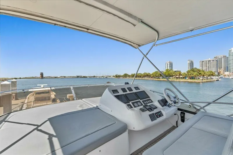 Cheers Yacht Photos Pics Flybridge view from 2009 Sunseeker Manhattan 52 yacht, overlooking waterfront cityscape.