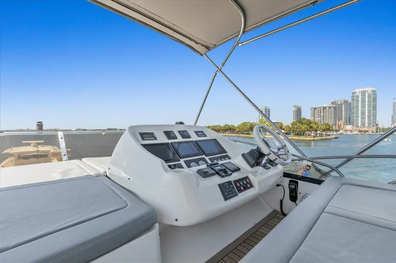 Cheers Yacht Photos Pics Flybridge of 2009 Sunseeker Manhattan 52 yacht with city skyline view.