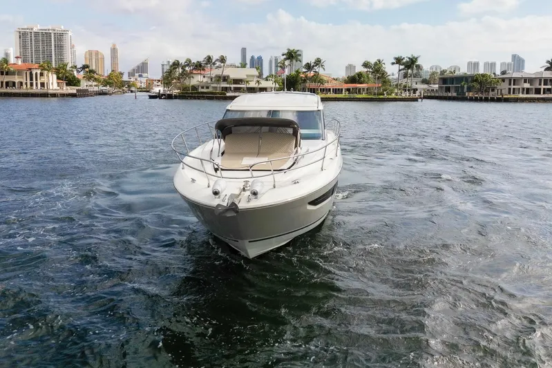 Notre Reve Yacht Photos Pics 2018 Jeanneau Leader 46 yacht cruising in a scenic waterfront setting.