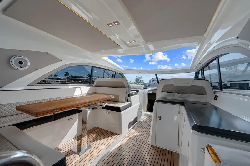 Notre Reve Yacht Photos Pics Luxurious interior of 2018 Jeanneau Leader 46 yacht with elegant seating and wooden table.