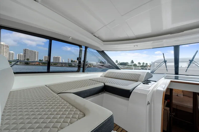 Notre Reve Yacht Photos Pics Interior of 2018 Jeanneau Leader 46 yacht with luxurious seating and waterfront view.
