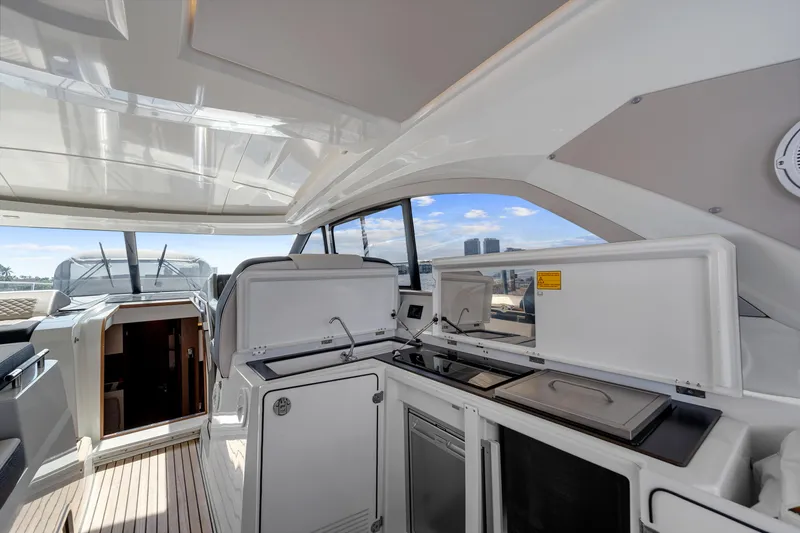 Notre Reve Yacht Photos Pics 2018 Jeanneau Leader 46 yacht interior with modern kitchen and open deck view.