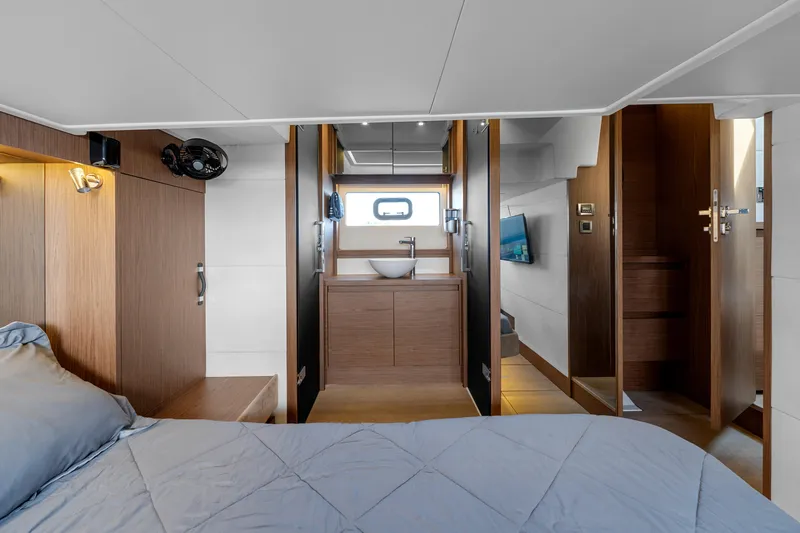 Notre Reve Yacht Photos Pics Luxurious interior of 2018 Jeanneau Leader 46 yacht, featuring a modern bedroom and bathroom.
