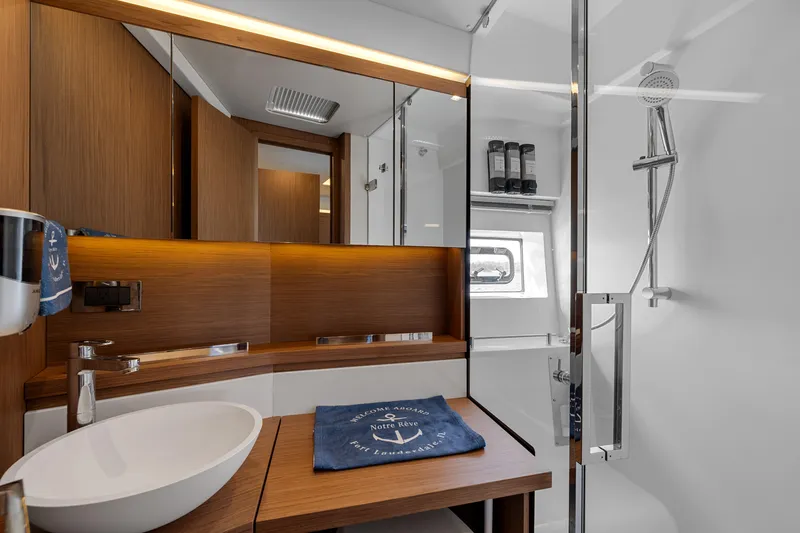 Notre Reve Yacht Photos Pics Luxurious bathroom interior of 2018 Jeanneau Leader 46 yacht with modern fixtures and wood accents.