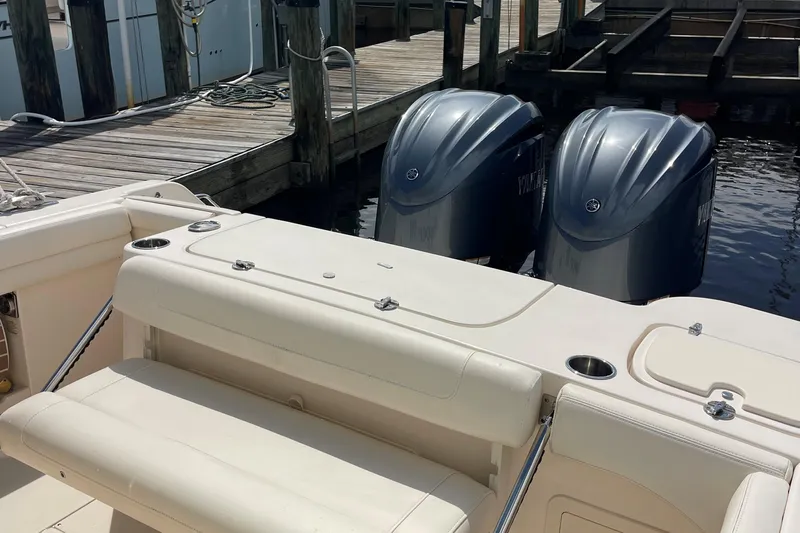  Yacht Photos Pics 2022 Grady-White Canyon 271 boat with twin outboard engines at dock.