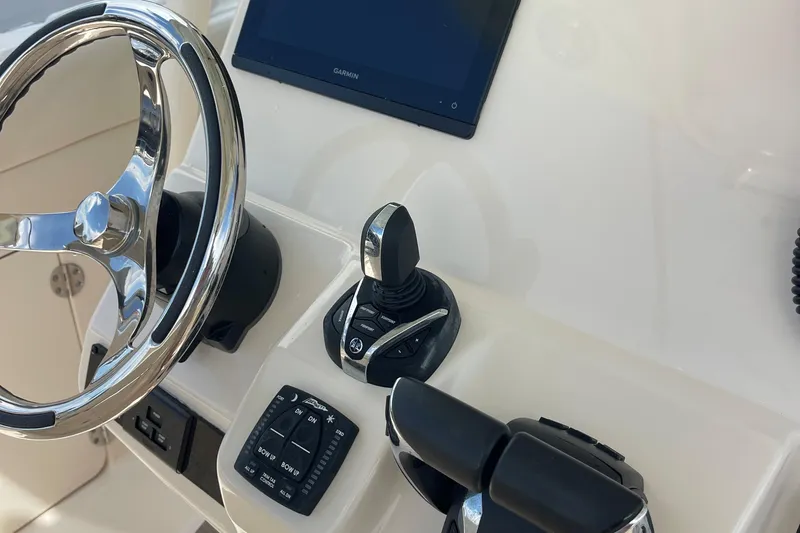  Yacht Photos Pics Steering console of 2022 Grady-White Canyon 271 boat with controls and display.