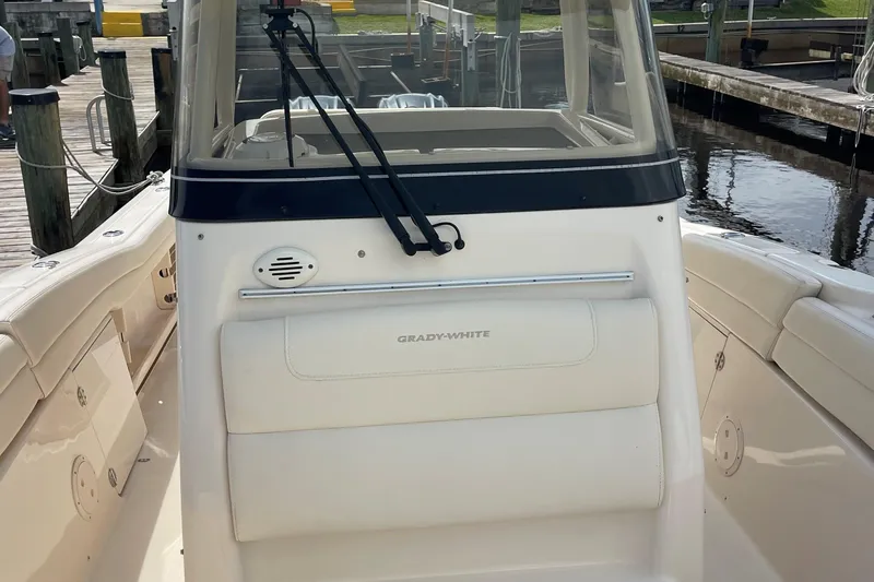  Yacht Photos Pics 2022 Grady-White Canyon 271 boat at dock, showcasing helm and seating area.