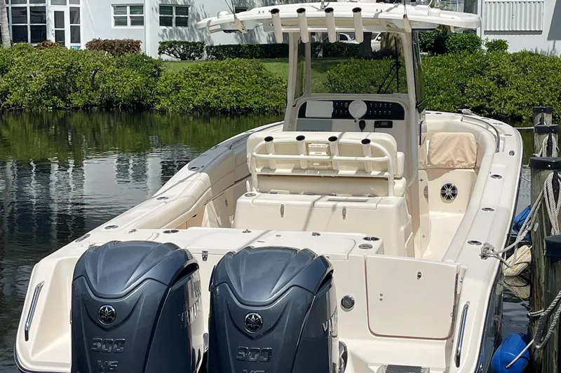  Yacht Photos Pics 2022 Grady-White Canyon 271 boat with dual Yamaha engines docked by waterfront.