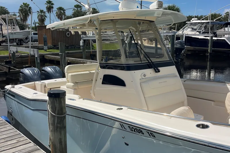  Yacht Photos Pics 2022 Grady-White Canyon 271 boat docked at marina with twin engines.