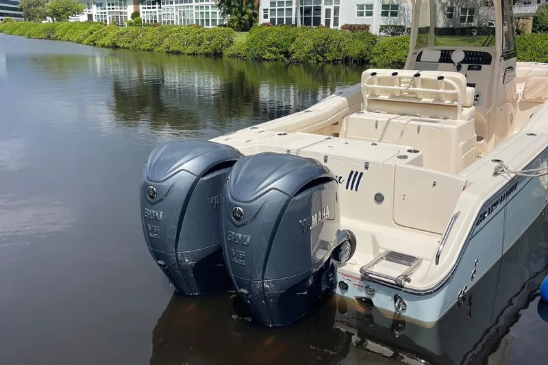  Yacht Photos Pics 2022 Grady-White Canyon 271 boat with twin Yamaha outboard engines docked on calm water.