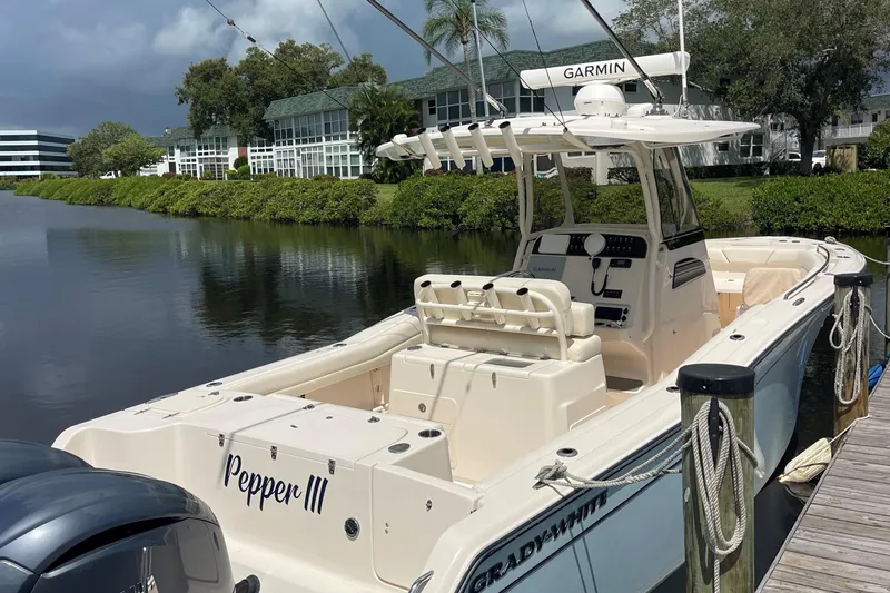  Yacht Photos Pics 2022 Grady-White Canyon 271 boat docked by a scenic waterfront.