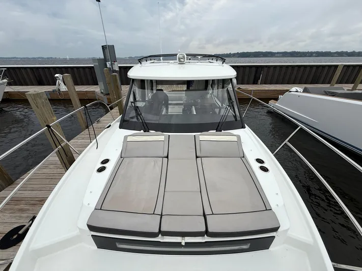  Yacht Photos Pics 2024 Jeanneau NC Weekender 895 Series 2 docked, featuring spacious deck and sleek design.