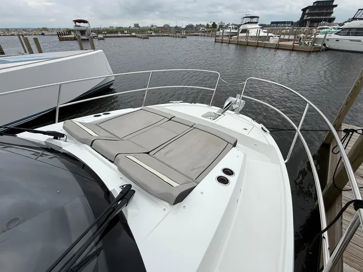  Yacht Photos Pics 2024 Jeanneau NC Weekender 895 Series 2 boat with cushioned deck, docked at marina.