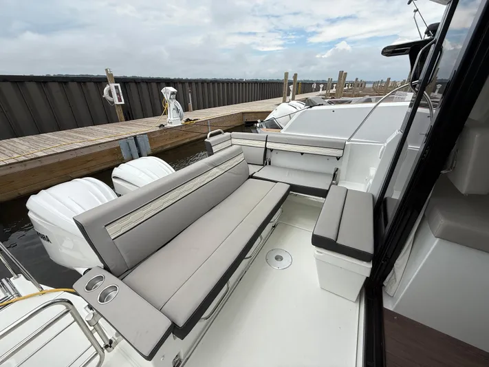  Yacht Photos Pics 2024 Jeanneau NC Weekender 895 Series 2 boat with spacious seating at the dock.