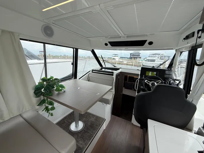  Yacht Photos Pics 2024 Jeanneau NC Weekender 895 Series 2 interior with helm, seating, and table.