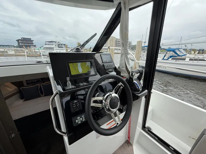  Yacht Photos Pics 2024 Jeanneau NC Weekender 895 Series 2 helm with navigation display and steering wheel.