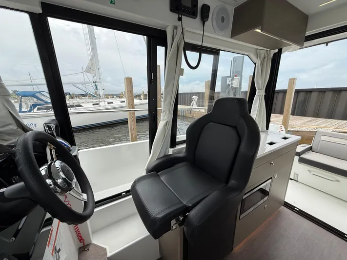  Yacht Photos Pics Interior of 2024 Jeanneau NC Weekender 895 Series 2 boat, featuring helm and seating area.