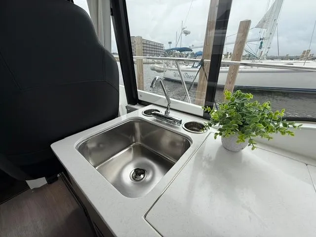 Yacht Photos Pics 2024 Jeanneau NC Weekender 895 Series 2 interior with sink and potted plant by window.