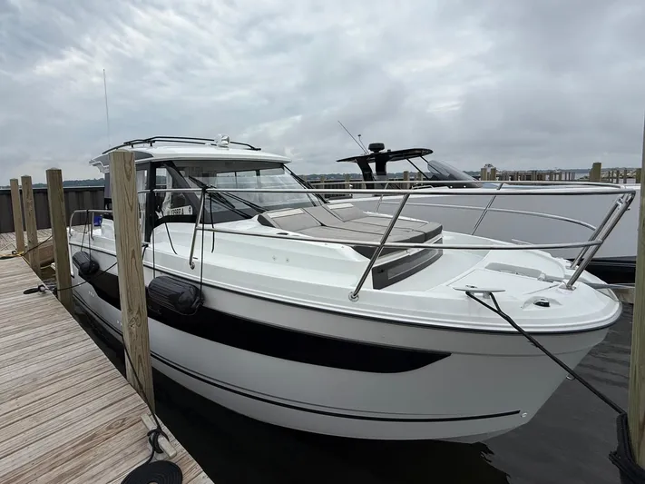  Yacht Photos Pics 2024 Jeanneau NC Weekender 895 Series 2 docked at marina under cloudy sky.