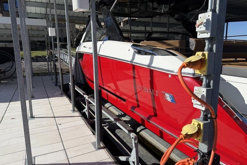 Red 2025 Cobalt R35 boat docked with visible power connections.