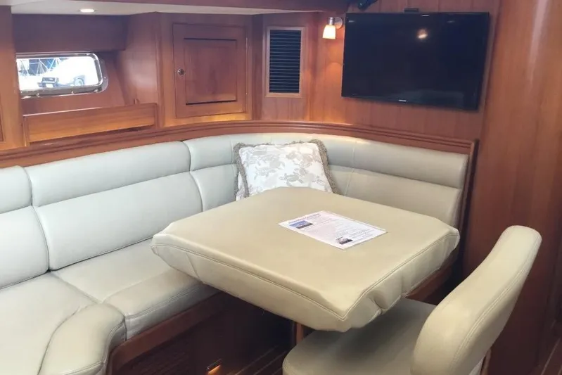 Patience Yacht Photos Pics Luxurious interior of 2012 Hylas 46 yacht with plush seating and wooden accents.