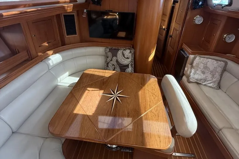 Patience Yacht Photos Pics Luxurious interior of 2012 Hylas 46 yacht with elegant wood and leather seating.