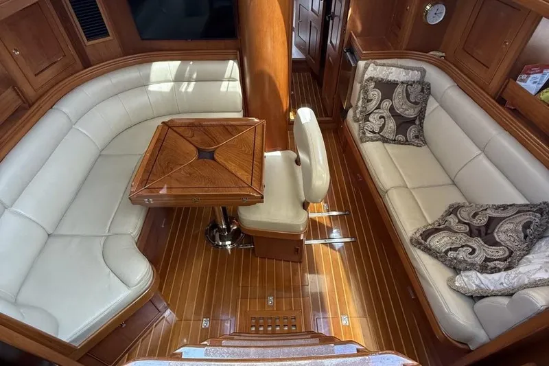 Patience Yacht Photos Pics Luxurious interior of a 2012 Hylas 46 yacht with elegant wood and leather seating.