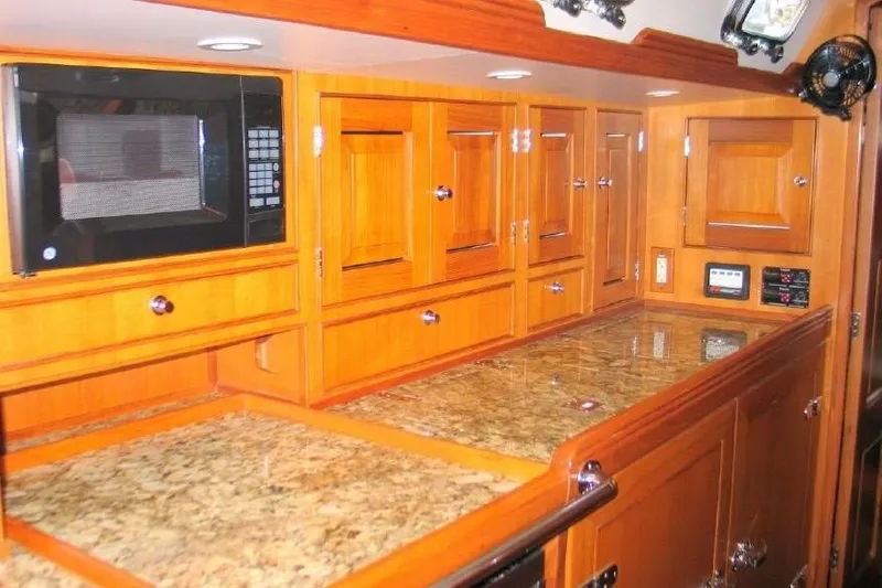 Patience Yacht Photos Pics Luxurious wooden kitchen interior of 2012 Hylas 46 yacht with granite countertops and microwave.