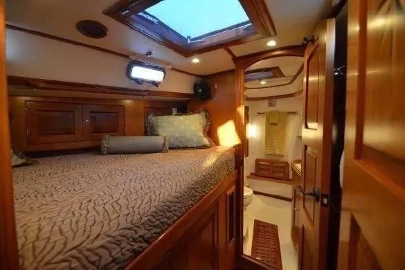 Patience Yacht Photos Pics Luxurious cabin interior of 2012 Hylas 46 yacht with cozy bed and wooden finish.