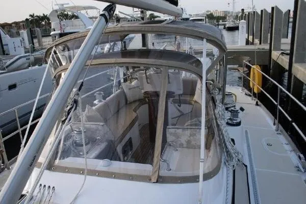 Patience Yacht Photos Pics Sailing yacht Hylas 46, 2012 model, docked at marina with clear cockpit enclosure.