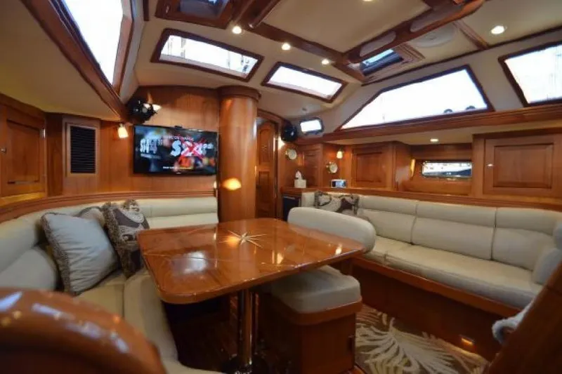 Patience Yacht Photos Pics Luxurious interior of 2012 Hylas 46 yacht with elegant wood finish and plush seating.