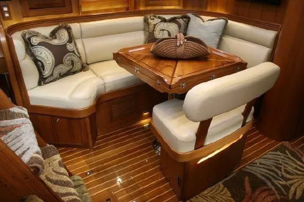 Patience Yacht Photos Pics Luxurious interior of a 2012 Hylas 46 yacht with elegant seating and wooden table.