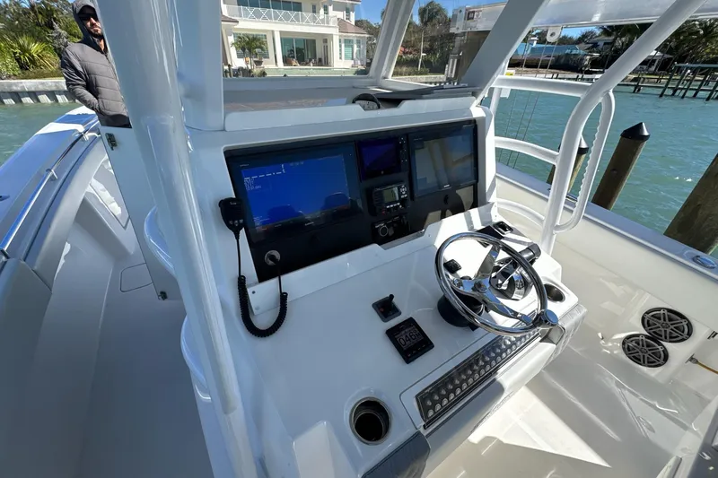 Reel Advice Yacht Photos Pics 2019 Invincible 39 Open Fisherman boat helm with modern navigation equipment and steering wheel.