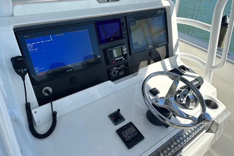 Reel Advice Yacht Photos Pics Control panel of 2019 Invincible 39 Open Fisherman with Garmin displays and steering wheel.