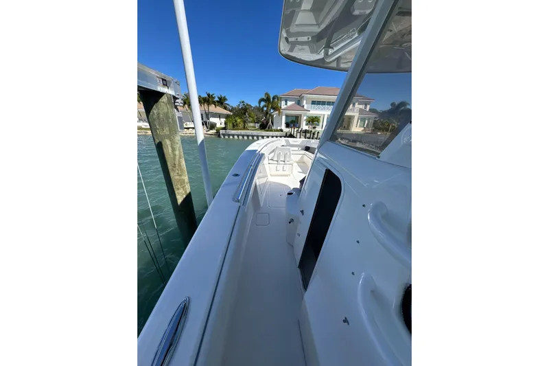 Reel Advice Yacht Photos Pics 2019 Invincible 39 Open Fisherman boat docked by waterfront homes.