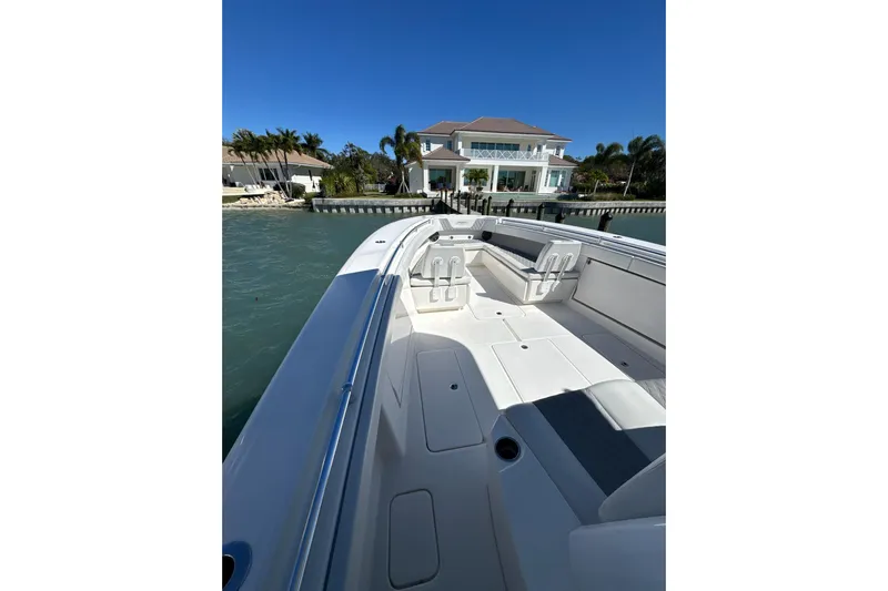 Reel Advice Yacht Photos Pics 2019 Invincible 39 Open Fisherman boat docked near waterfront home.
